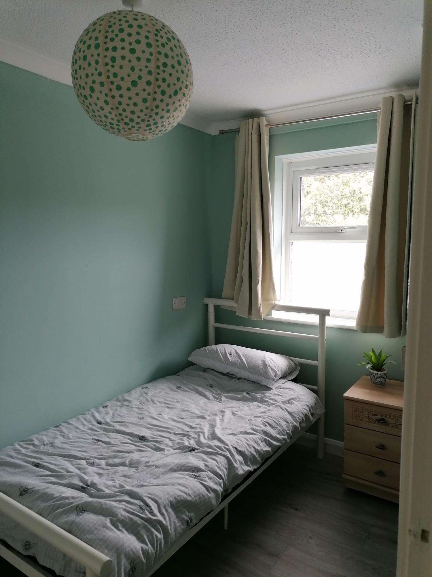 Bedroom with a single bed and bedside furniture